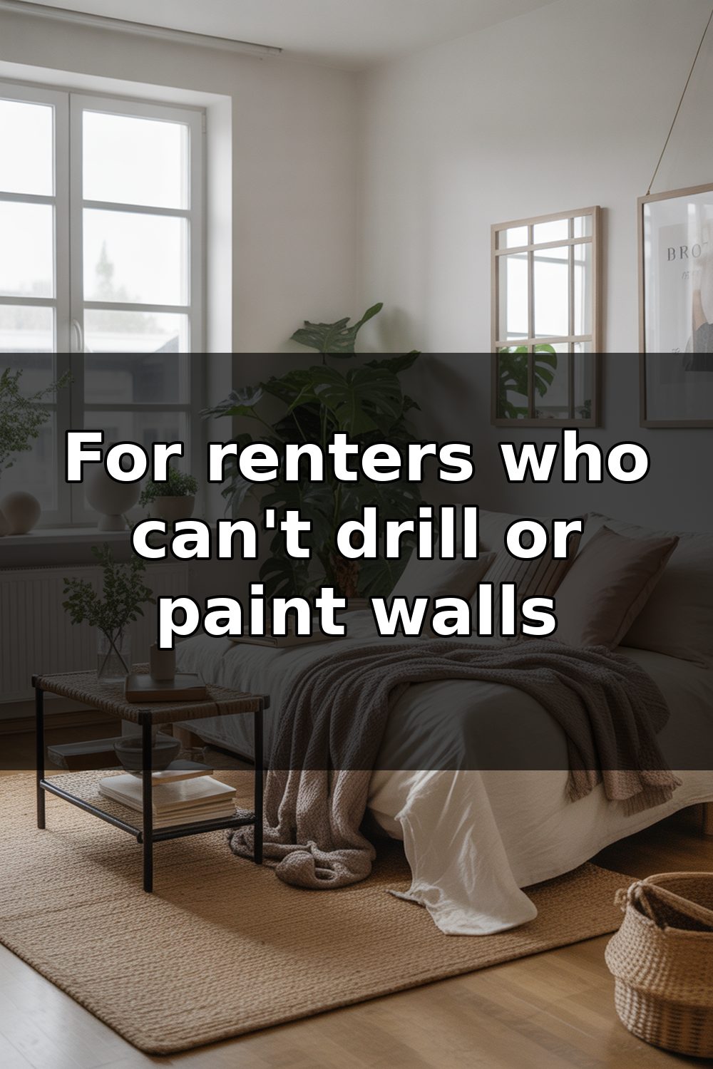 A small studio apartment with a bed, minimal furniture, and neutral-toned walls decorated with removable wall hangings and plants.